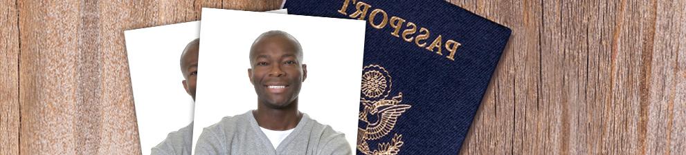 Passport cover and passport photo on desk.